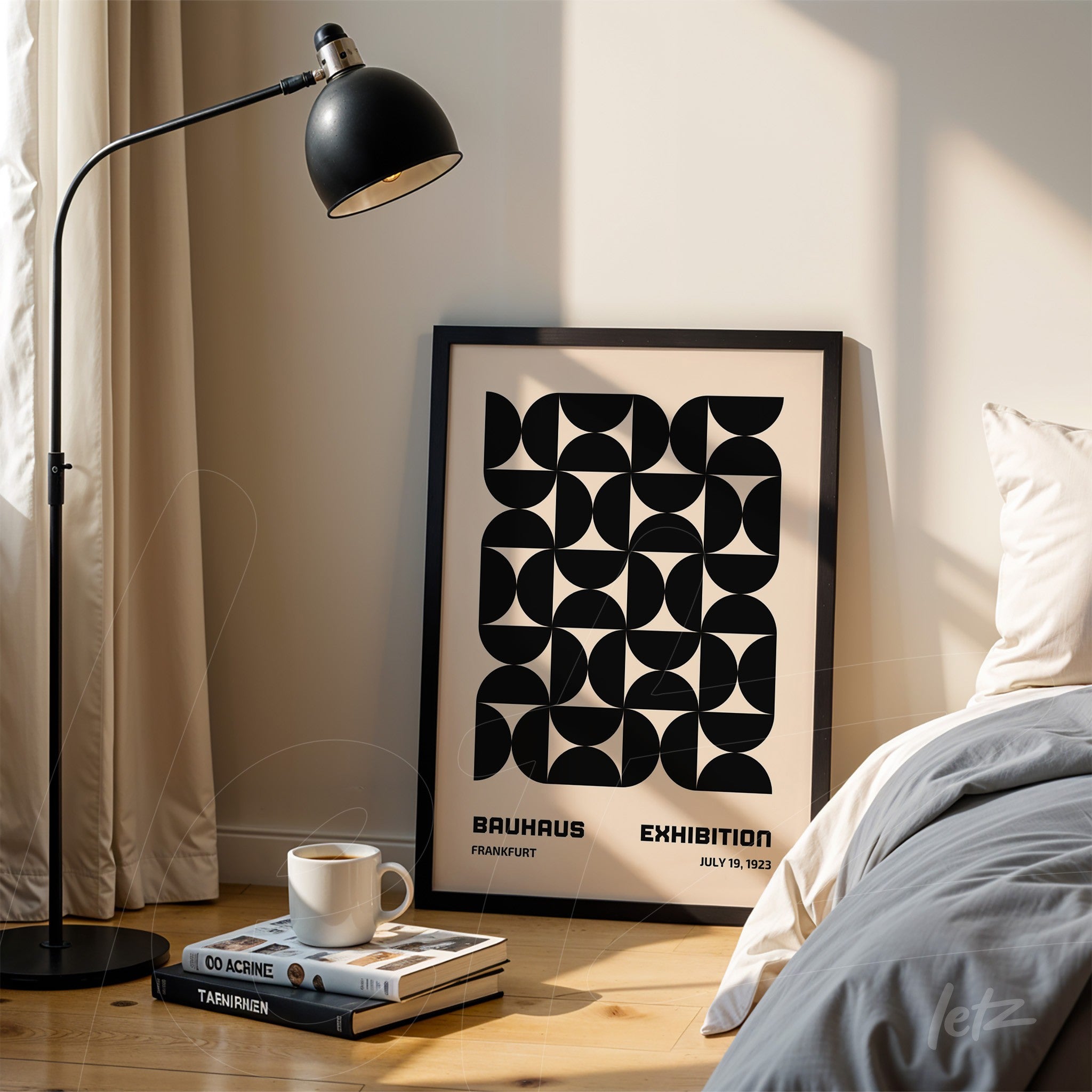 black and white geometric design poster leaning against wall near modern lamp
