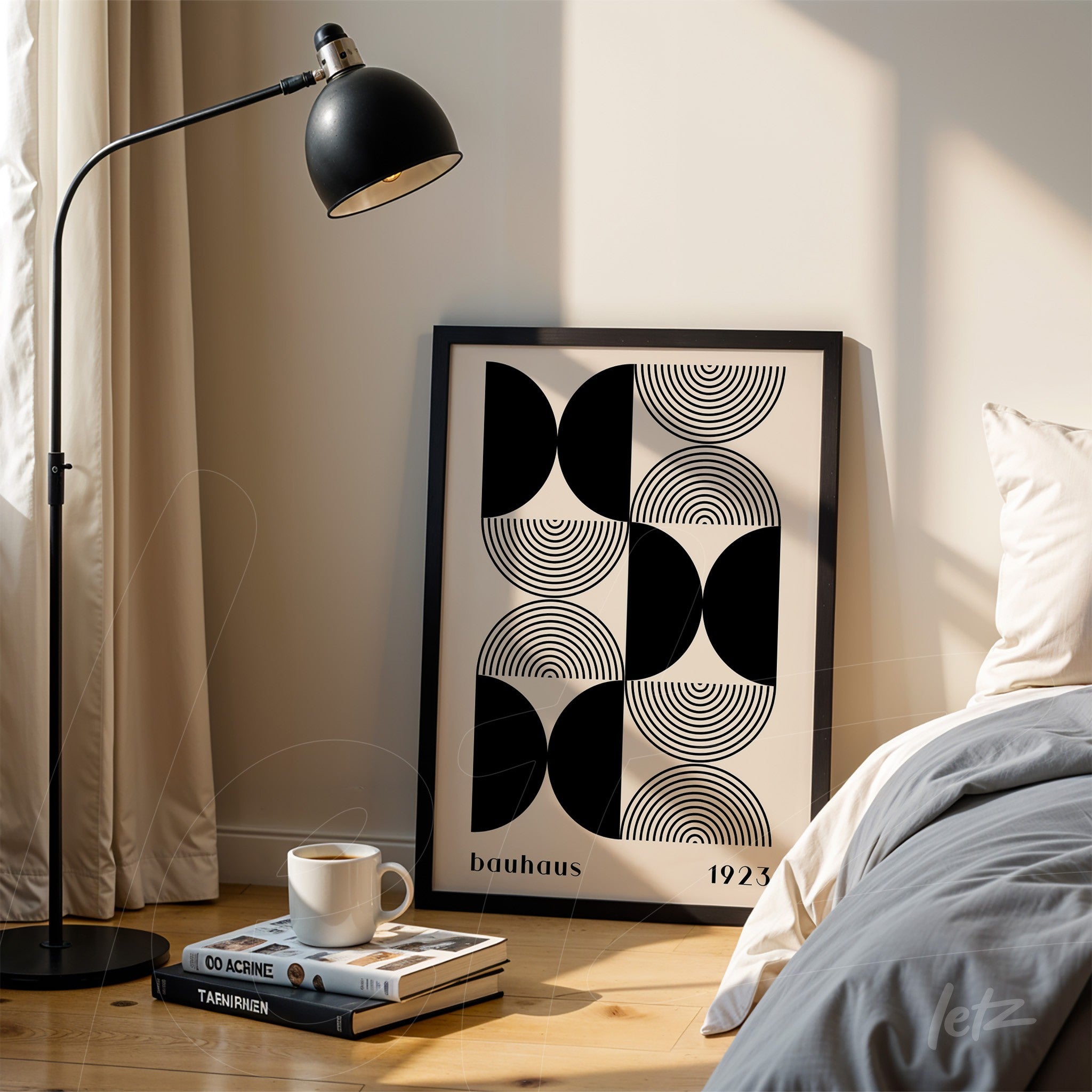 poster print featuring black and white geometric bauhaus style art leaning against a wall beside a bed