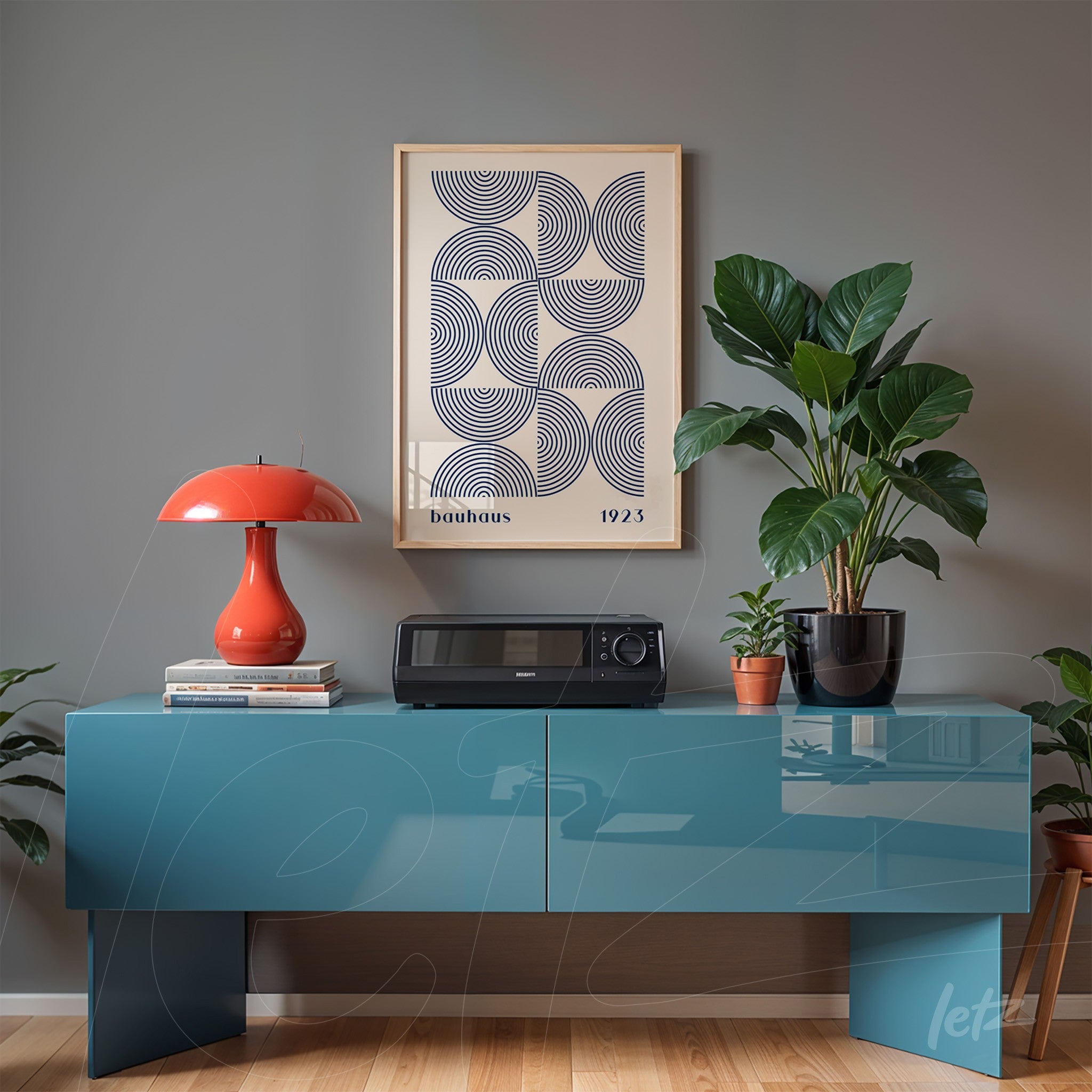 modern decor with a poster print of geometric bauhaus style design in light frame above blue sideboard