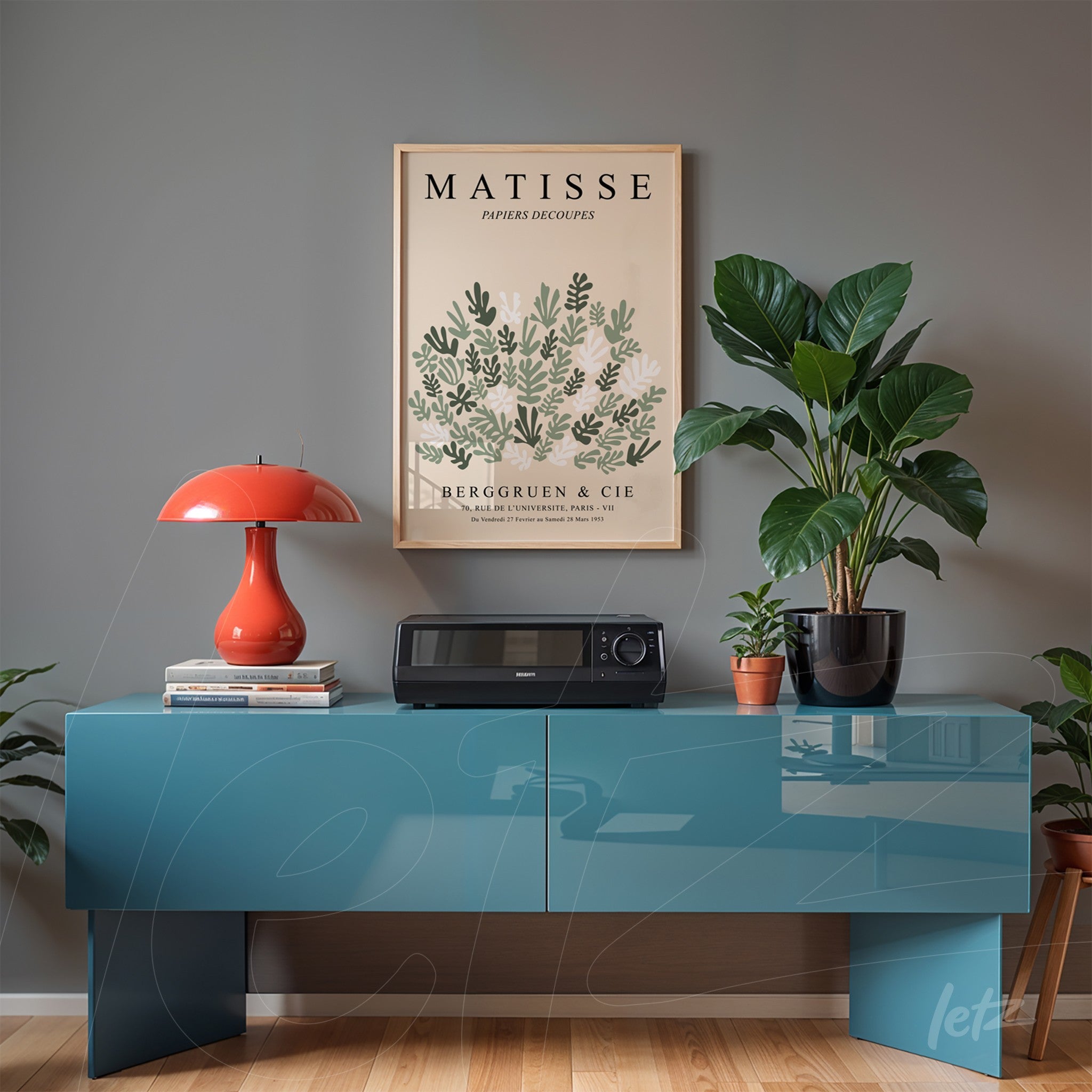 framed wall art featuring matisse design displayed on gray wall with blue console table and plant in the background