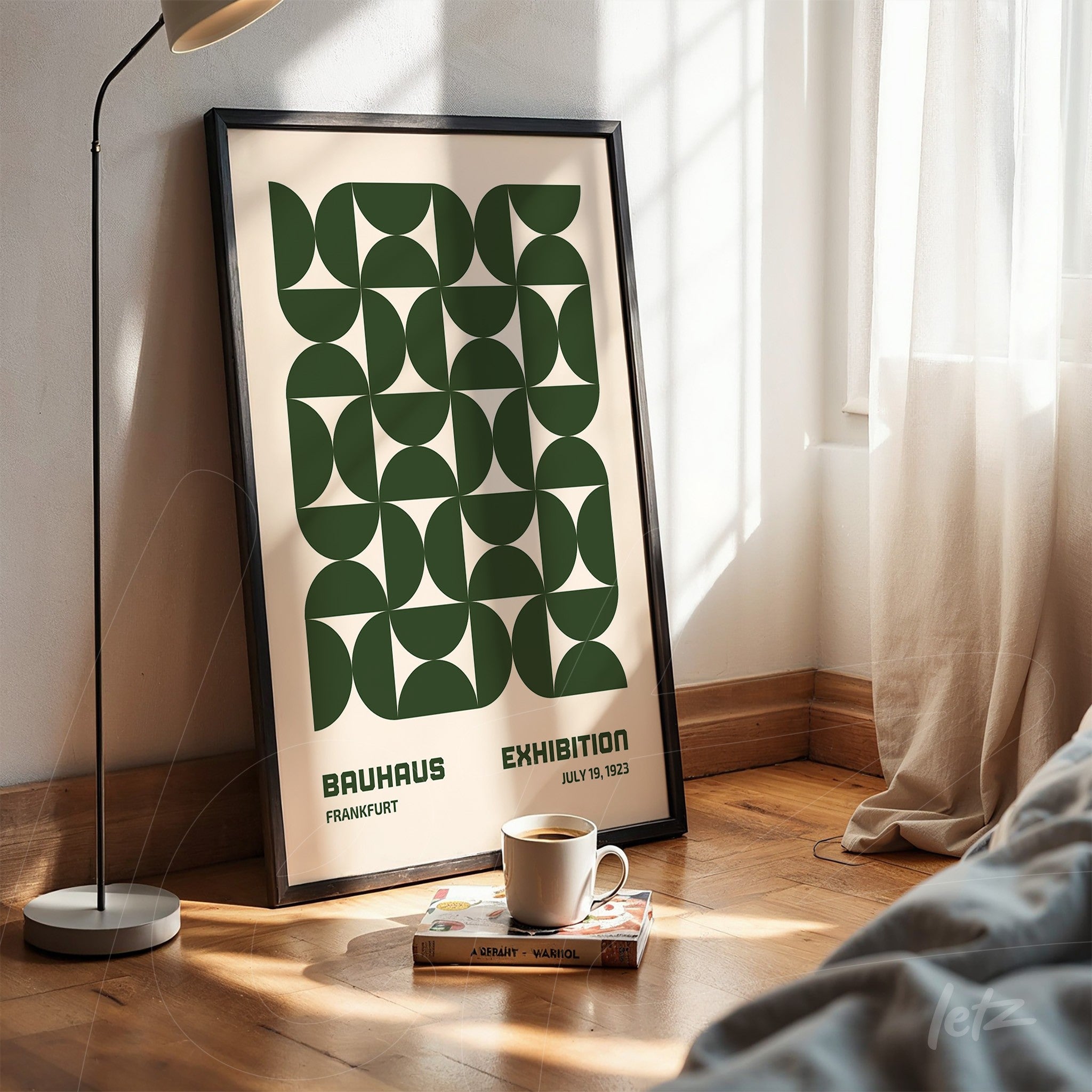 poster featuring green geometric pattern with text 'bauhaus exhibition, frankfurt, july 19, 1923', framed and leaning against the wall