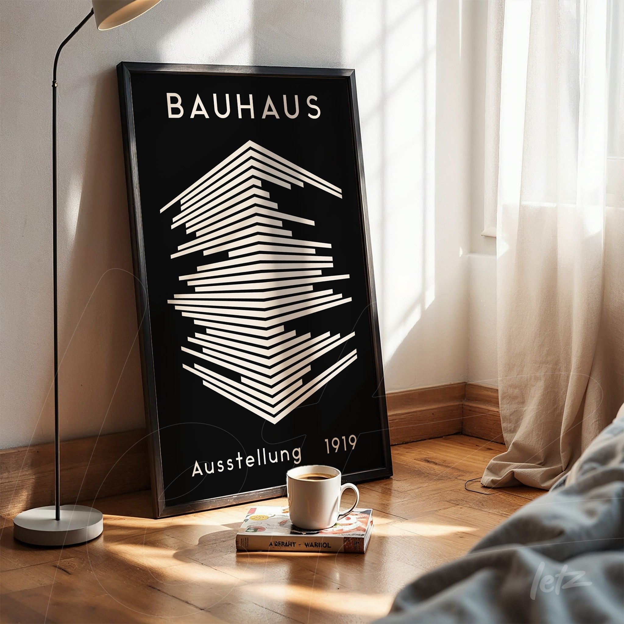 framed artwork leaning against wall featuring geometric Bauhaus style in black and white with black frame