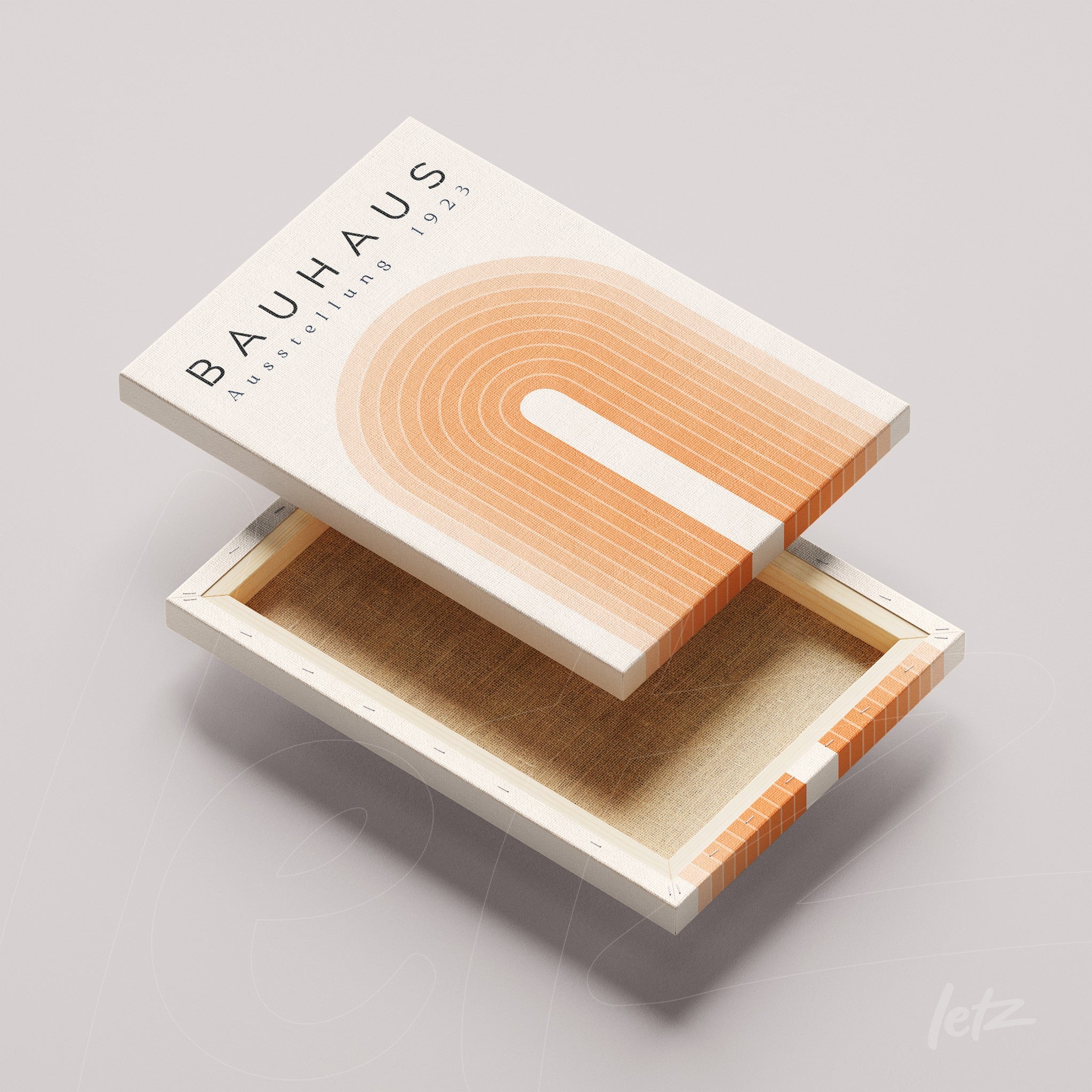 canvas print with geometric bauhaus style art in orange tones and text displayed on light surface