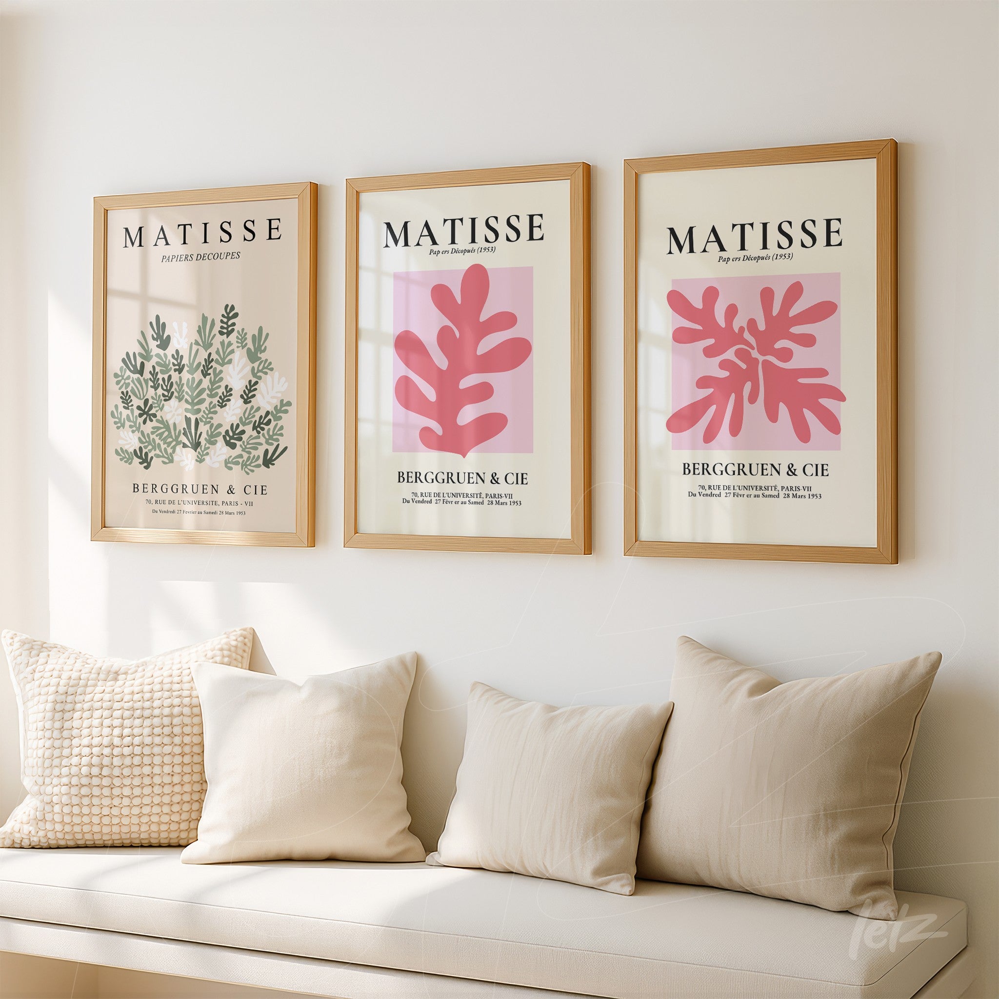 composition of three framed wall art pieces by Matisse in light wood frames displayed against a white wall