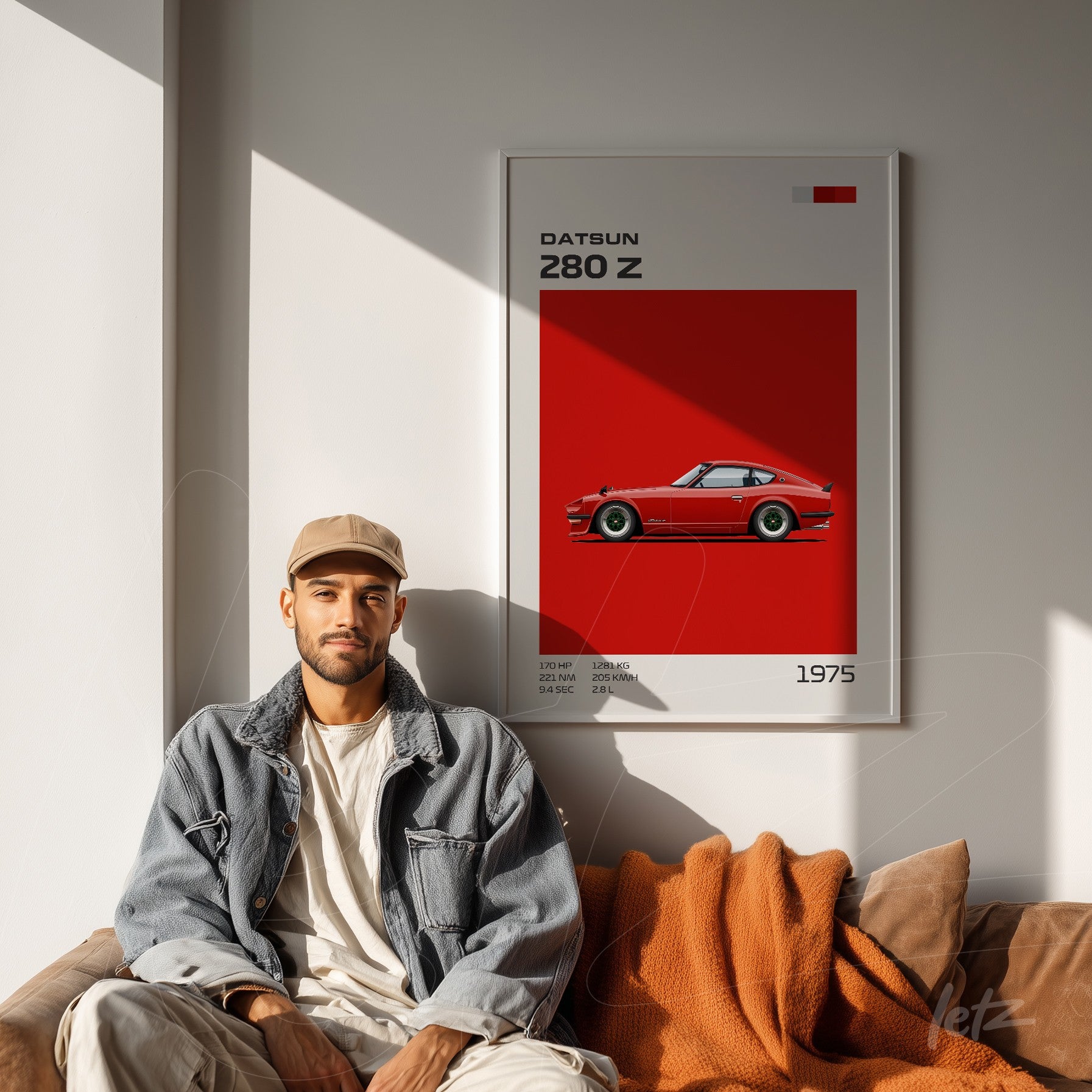 framed retro artwork of Datsun 280 Z against red background displayed beside a man sitting on a brown sofa