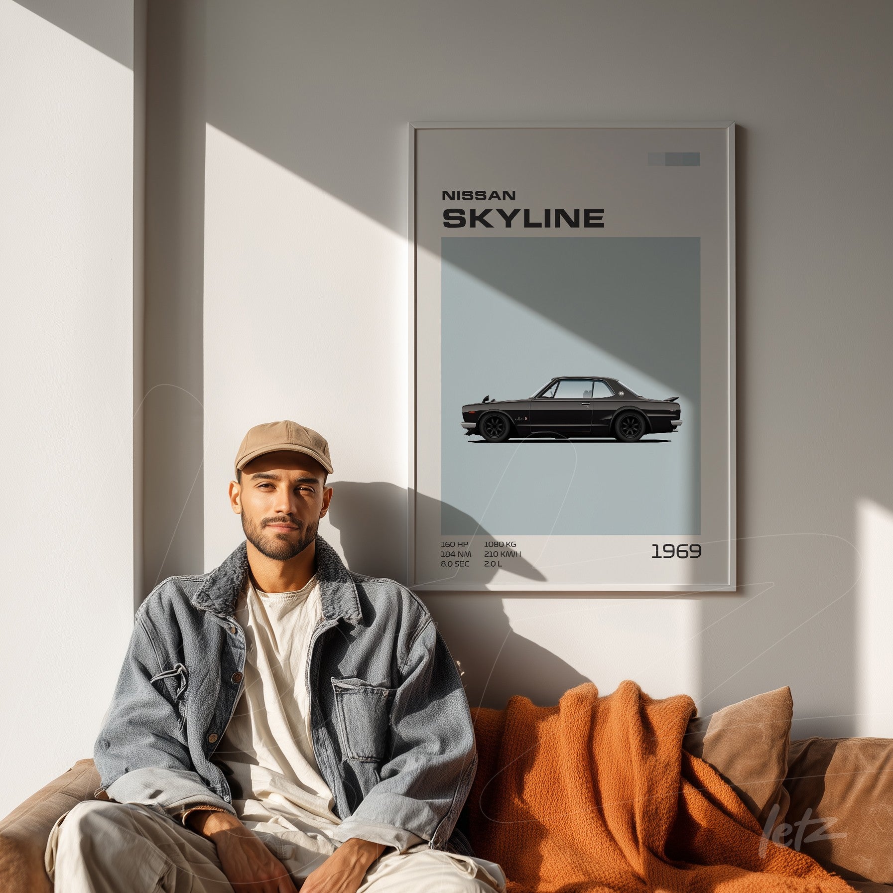 framed art piece featuring a Nissan Skyline car on a light blue background displayed in a modern setting with a leather sofa