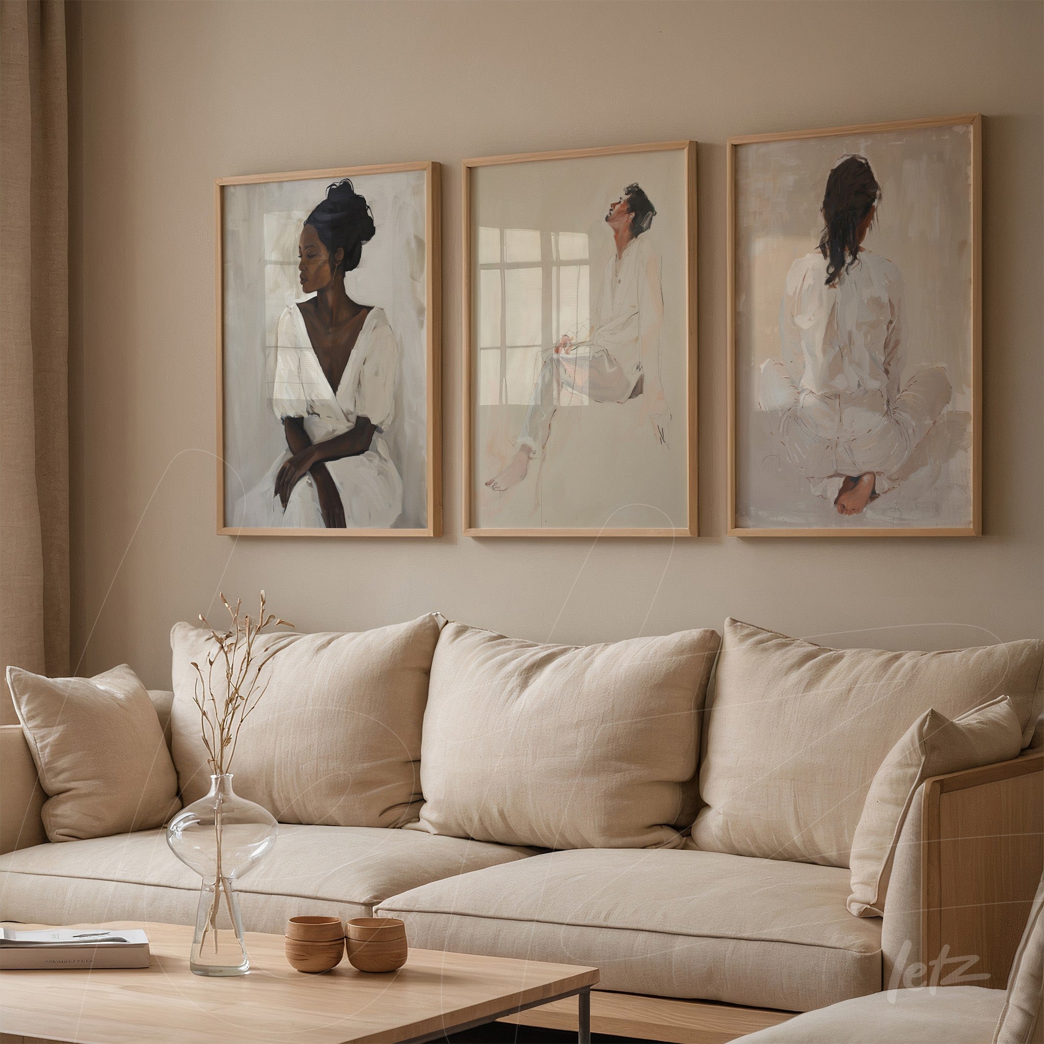 collection of framed artworks featuring female portraits in light wood frames displayed on a neutral wall in a living room with a light sofa