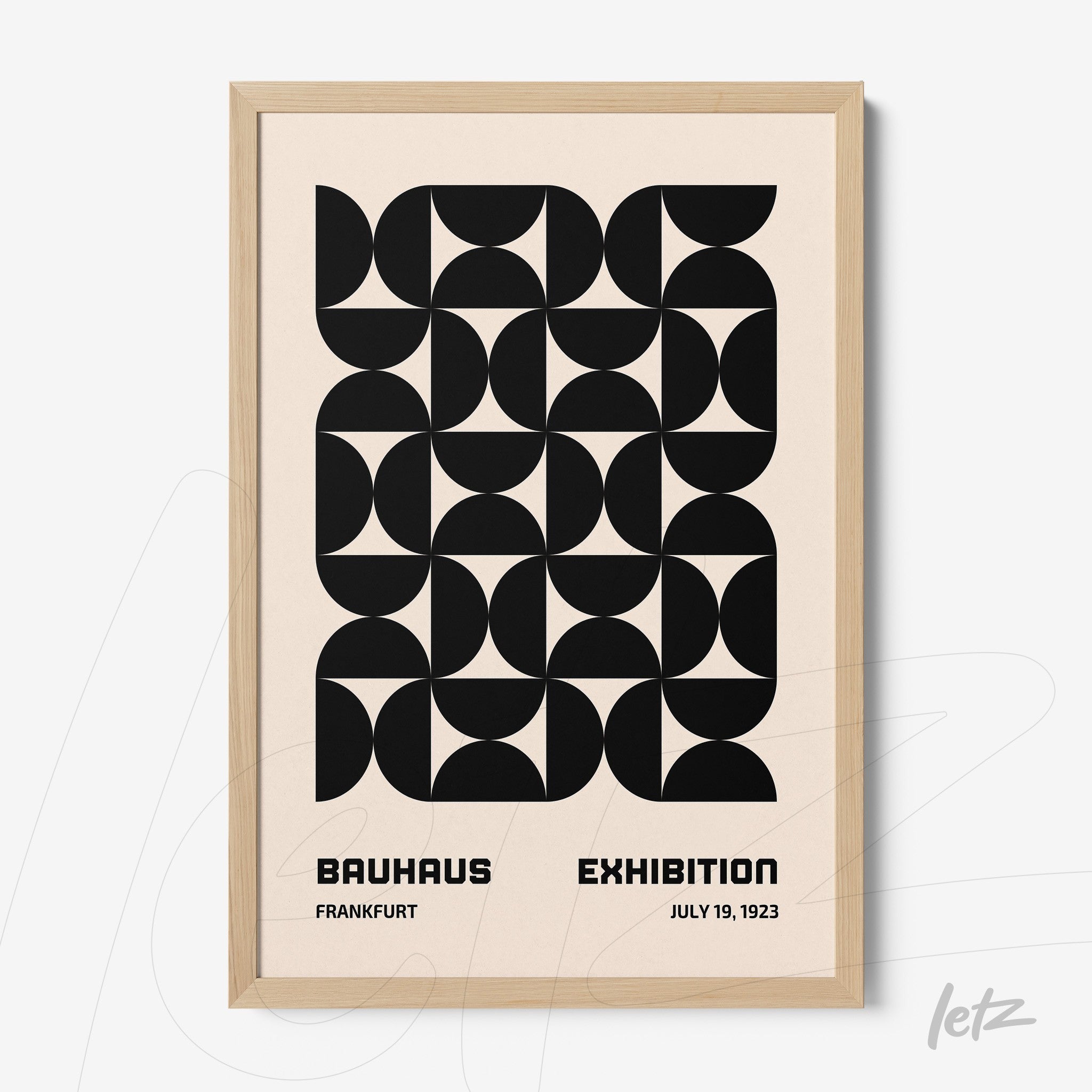 poster with black geometric design on beige background and light wood frame