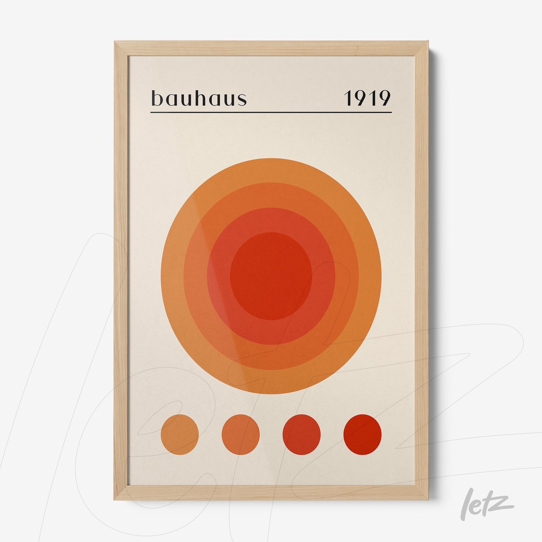 geometric art print with orange and red concentric circles in Bauhaus style with light wood frame