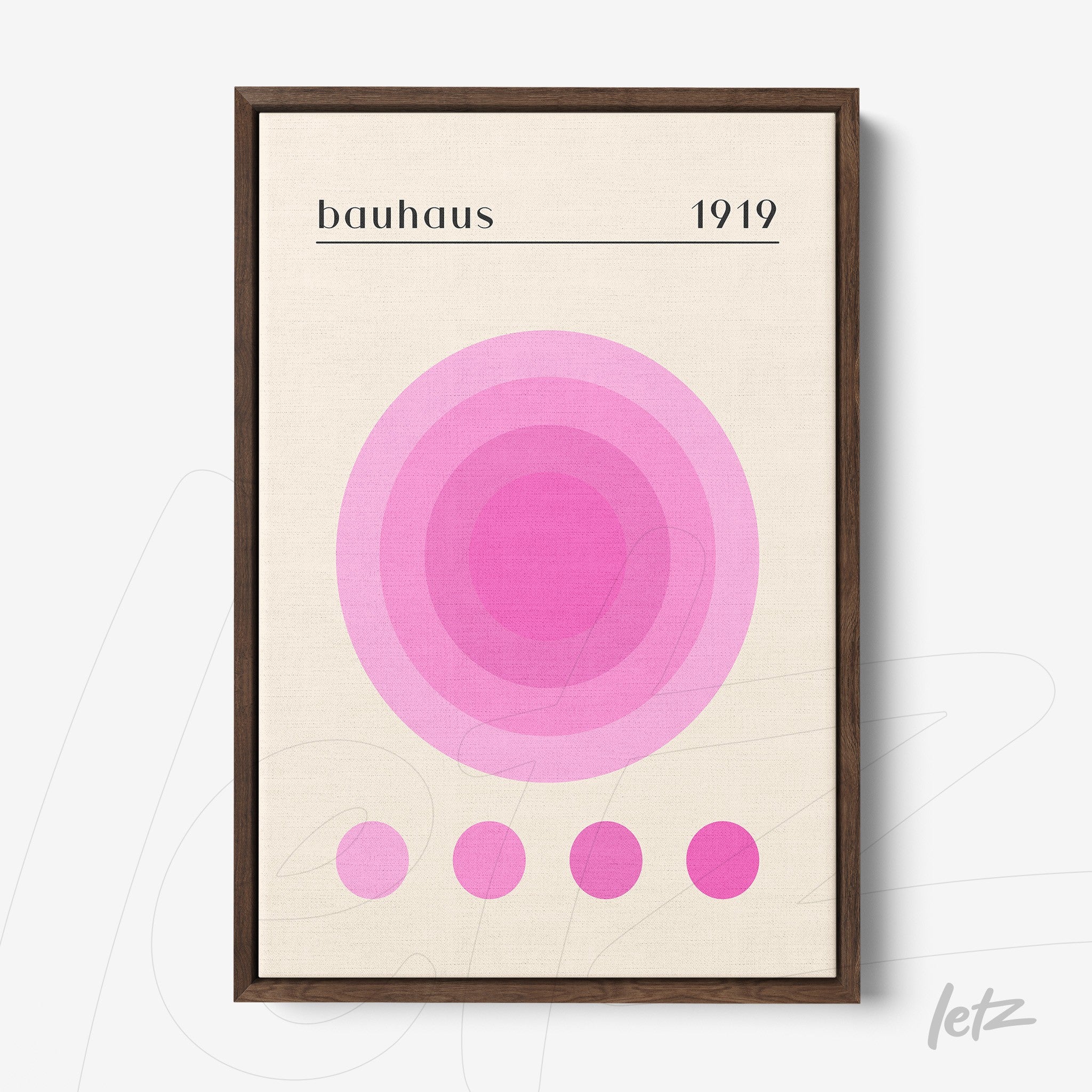 minimalist geometric wall art with shades of pink, dark brown frame, displayed on a white wall