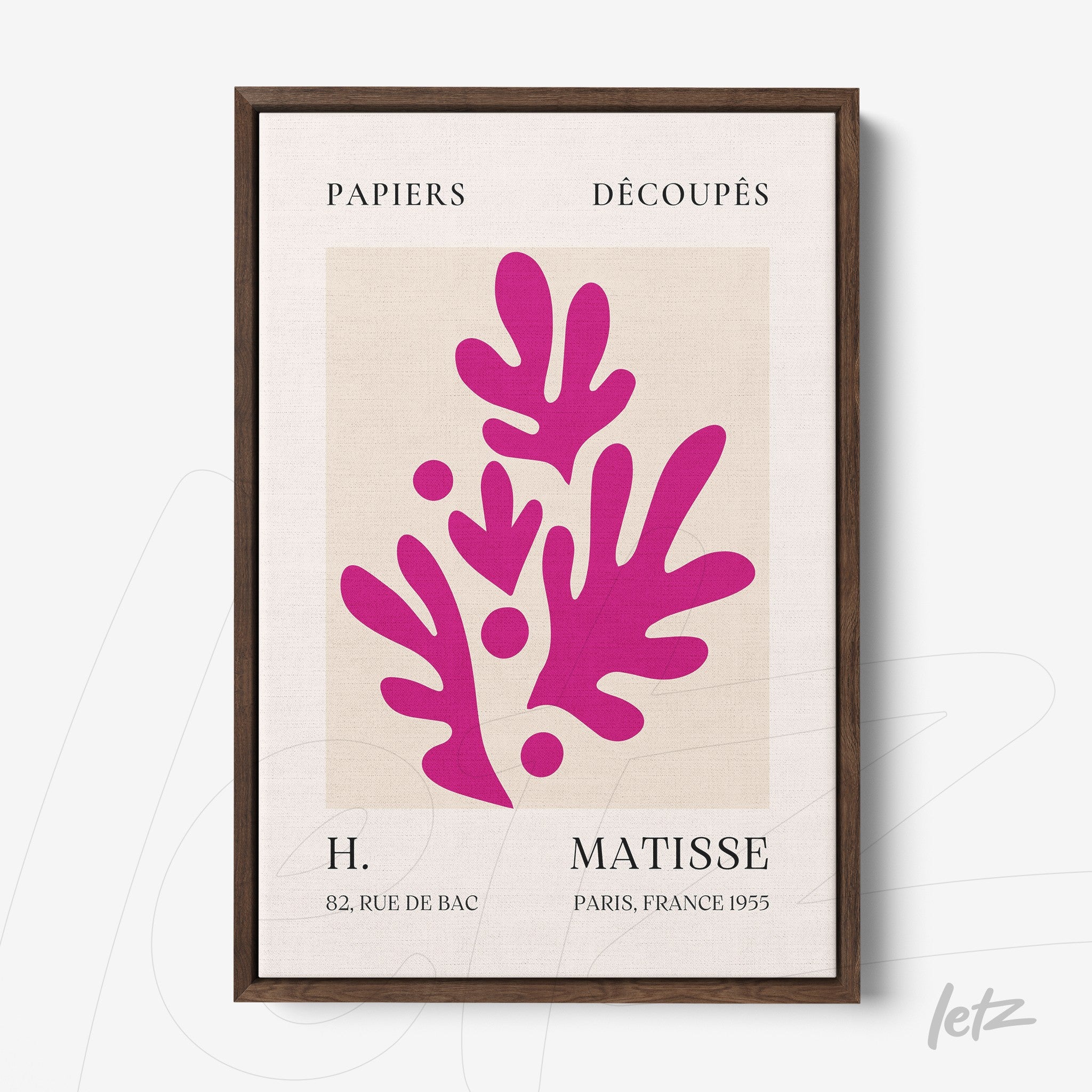 framed modern art piece in vibrant pink tones inspired by paper cut patterns with dark wooden frame