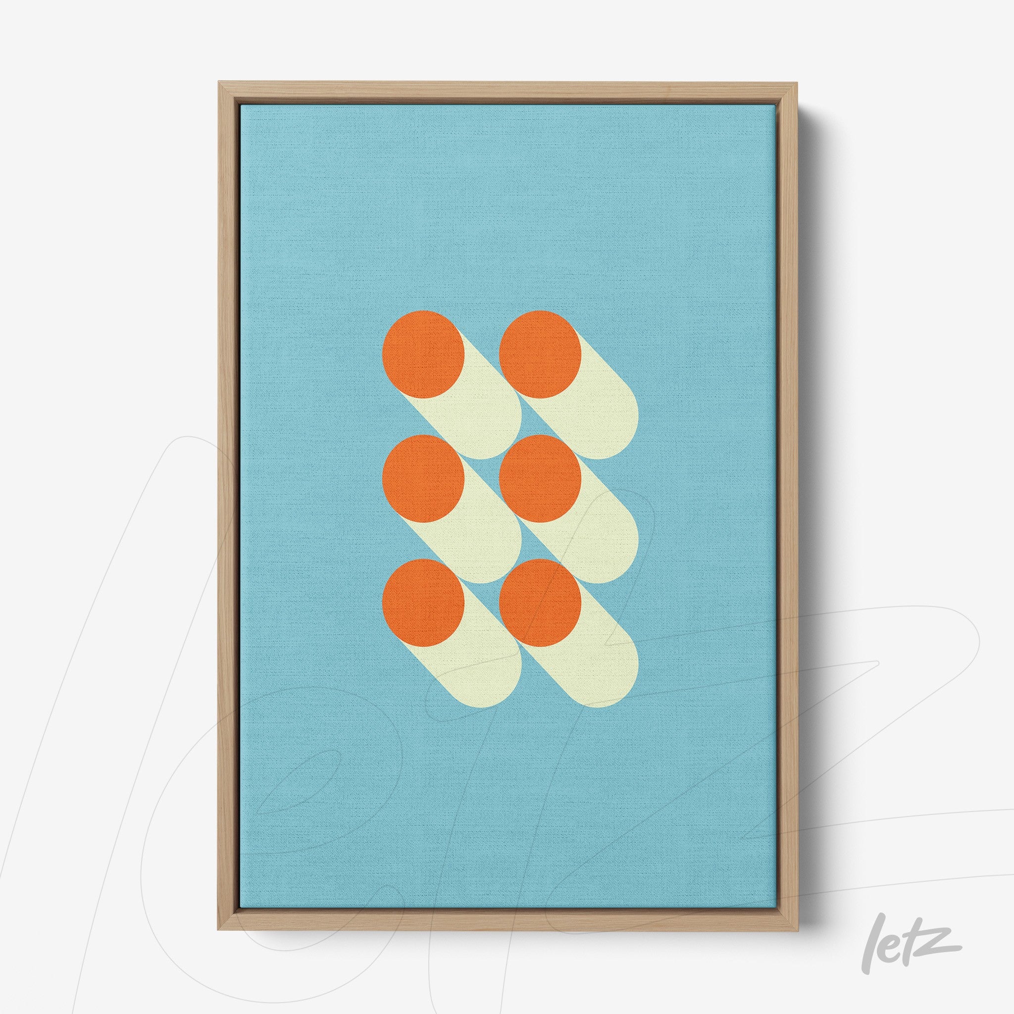 canvas wall art featuring geometric design with orange circles on light blue background framed in light wood