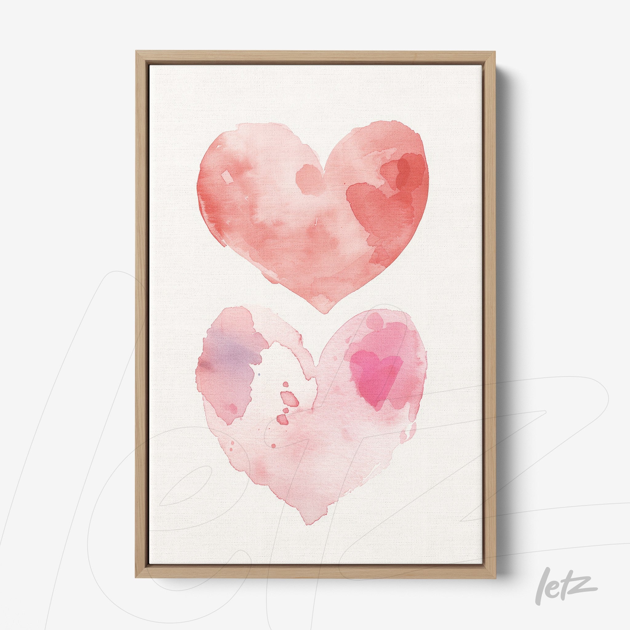 framed wall art featuring watercolor illustration of two interconnected hearts in shades of pink with light wood frame