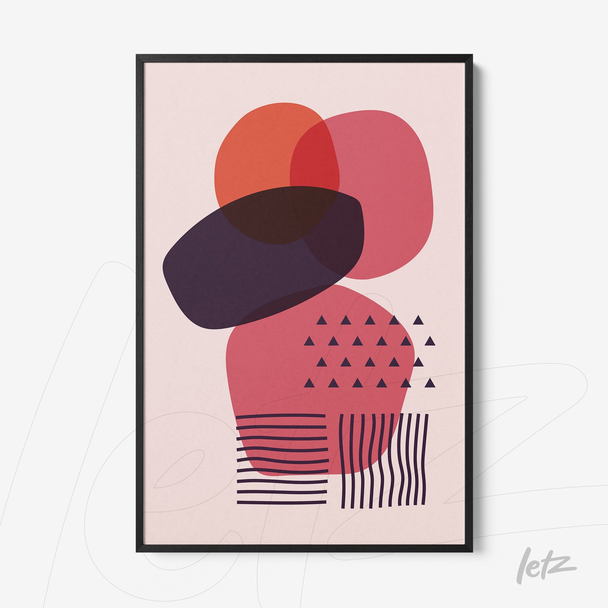 poster print of abstract geometric art with colorful shapes in red and purple tones in a black frame