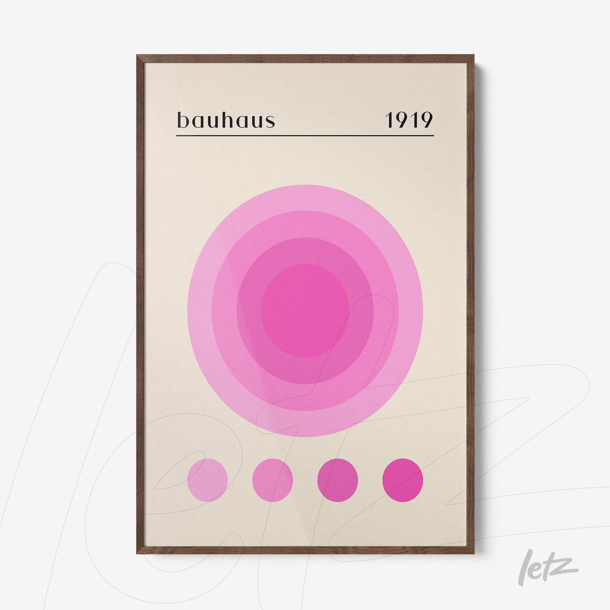 poster print featuring minimalist art of concentric circles in shades of pink, framed in dark wood