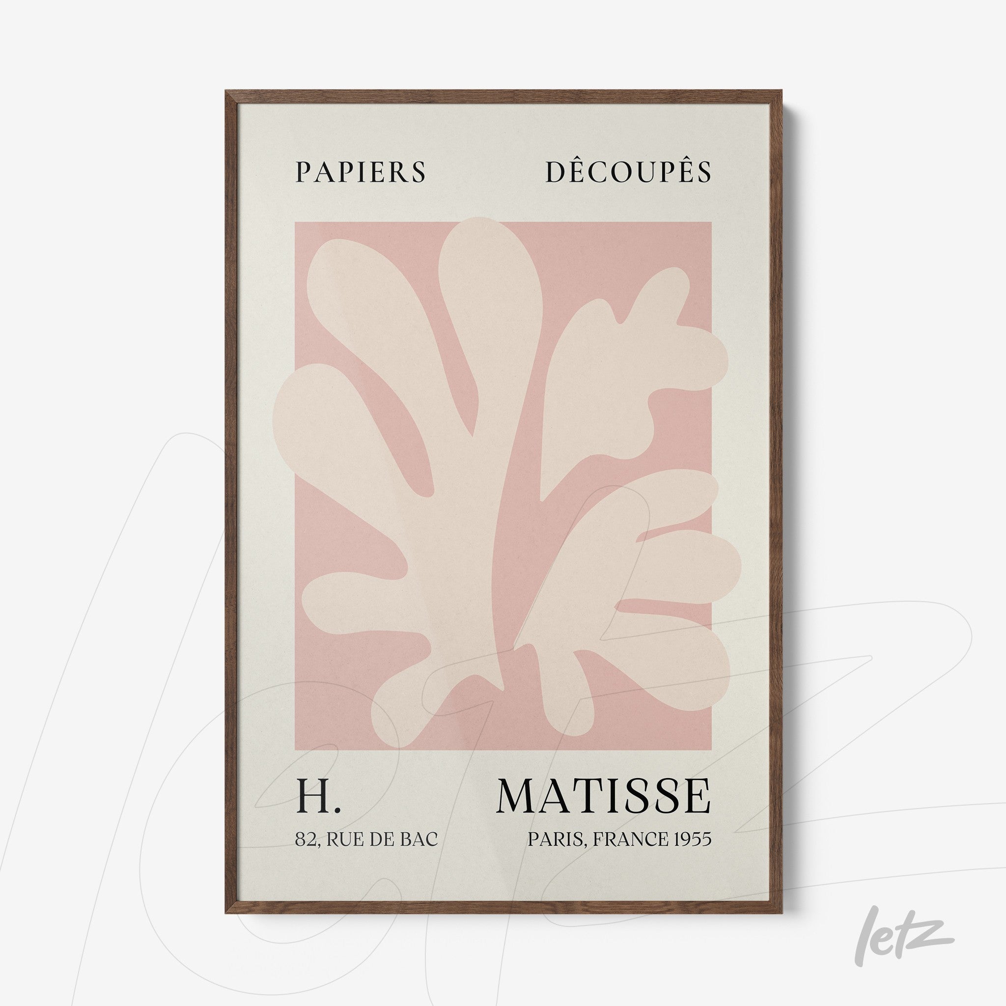 framed wall art with modern cut-out design in shades of pink on light background