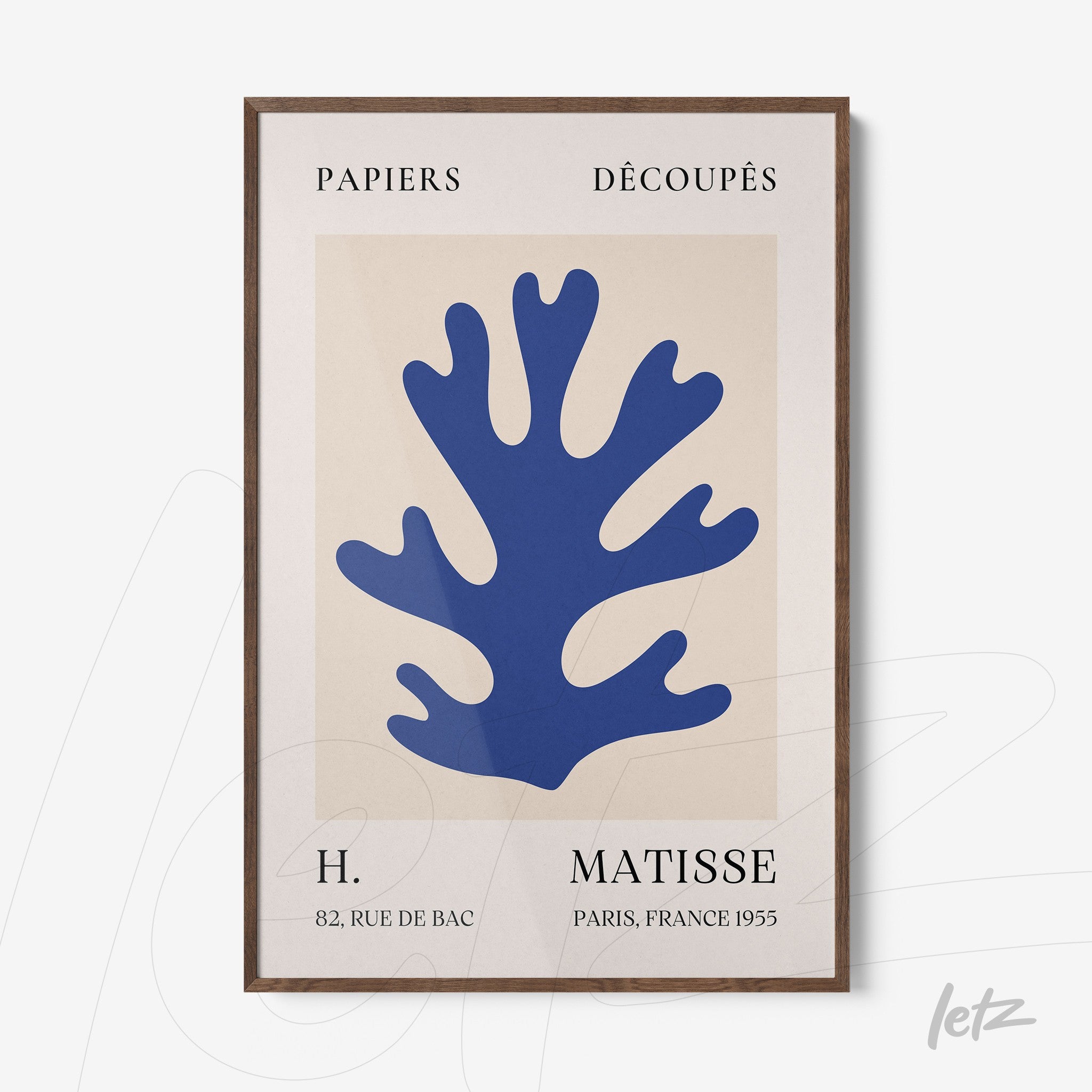 abstract wall art featuring a blue coral shape with a light wood frame