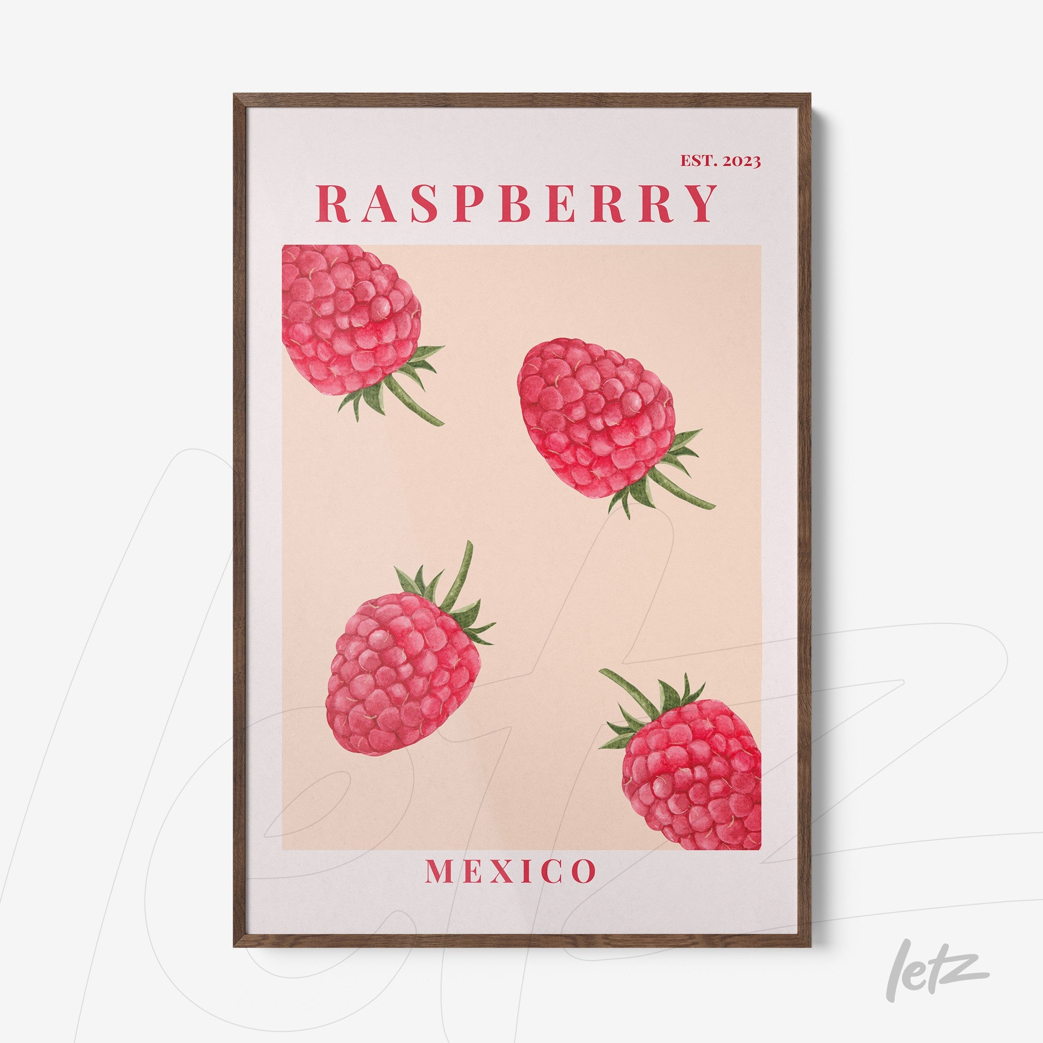 framed wall art featuring illustrations of raspberries on a light background with dark wood frame and red text