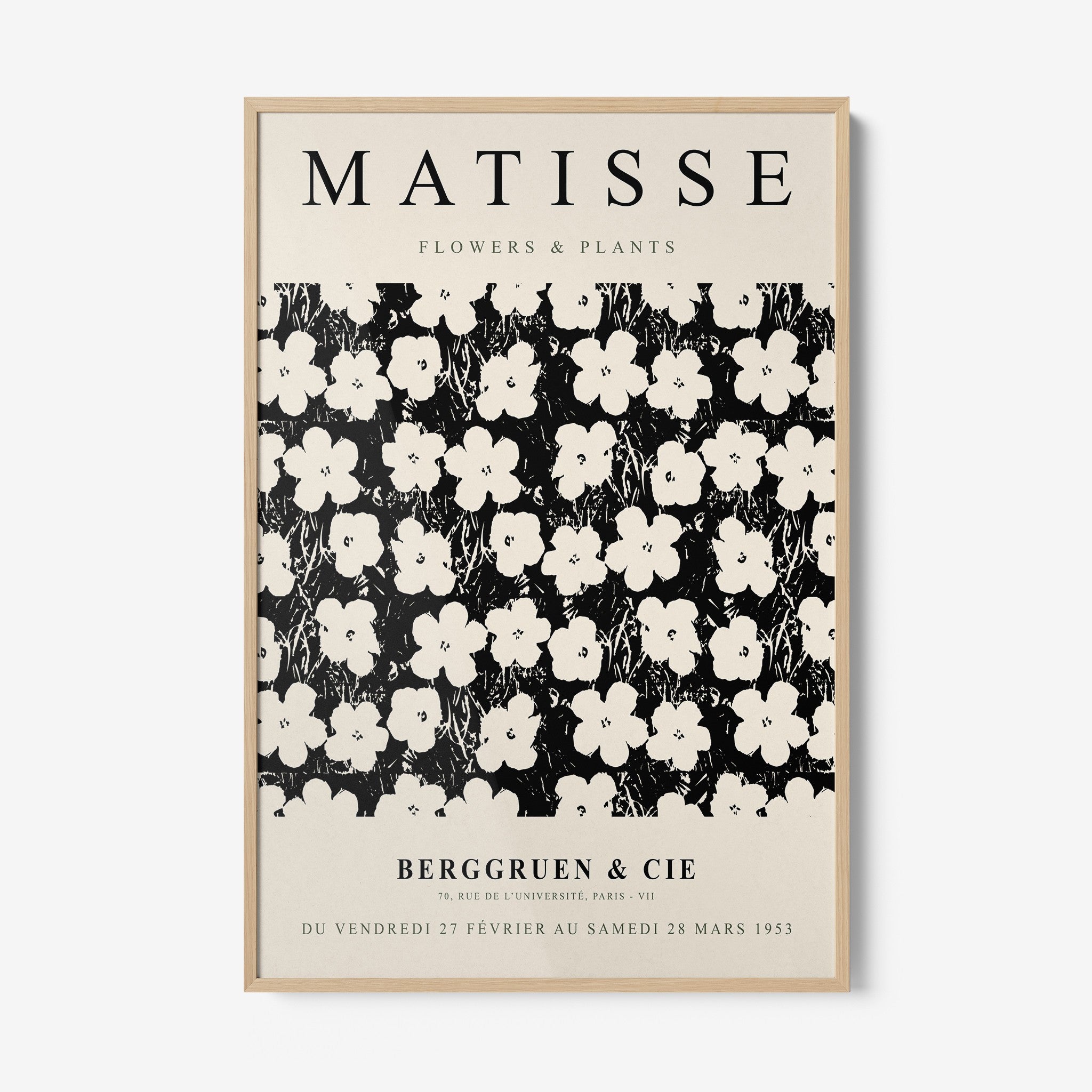 framed wall art featuring a stylized floral pattern in white on a black background with a light frame