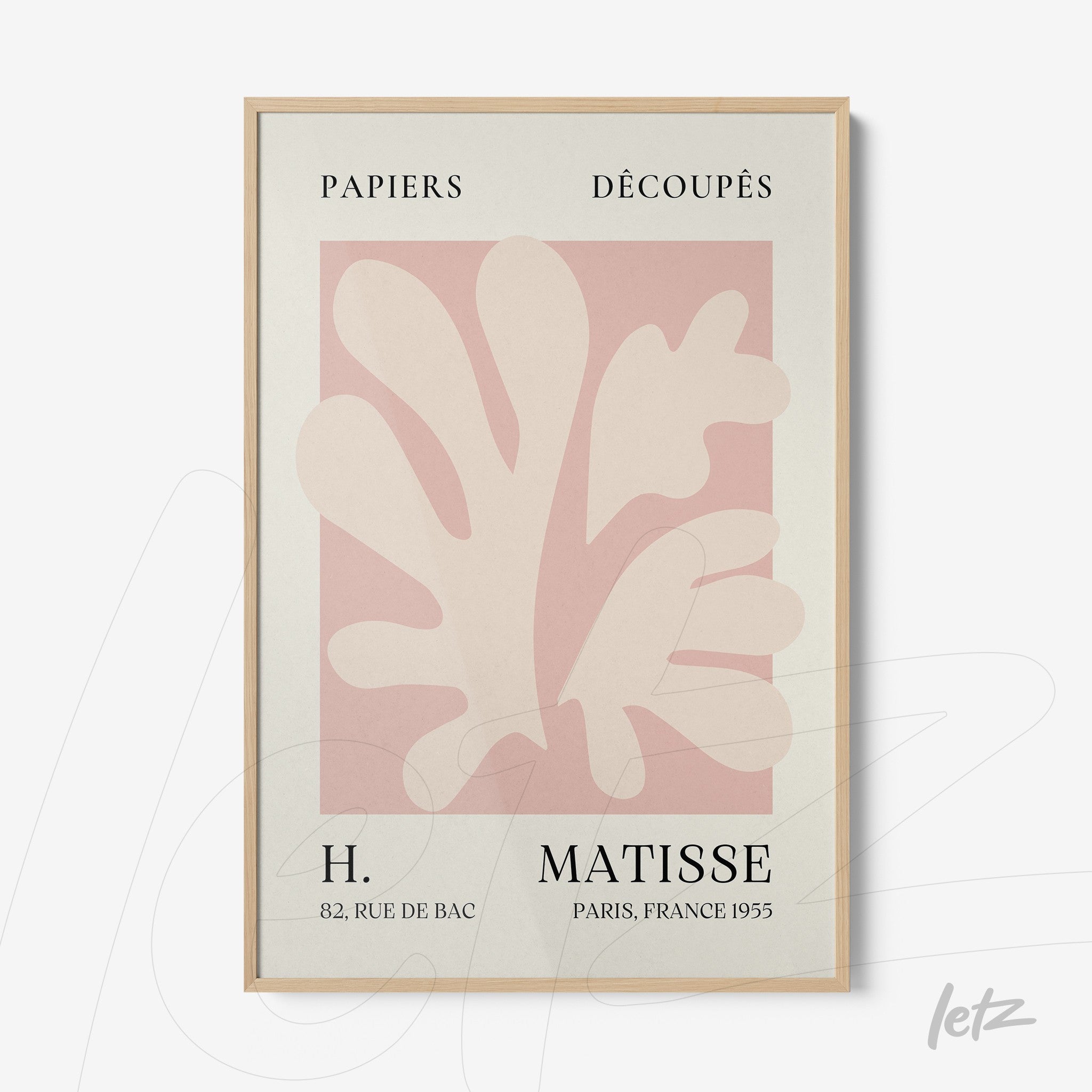 framed artwork featuring abstract shapes in pink and beige on a light background with light wooden frame