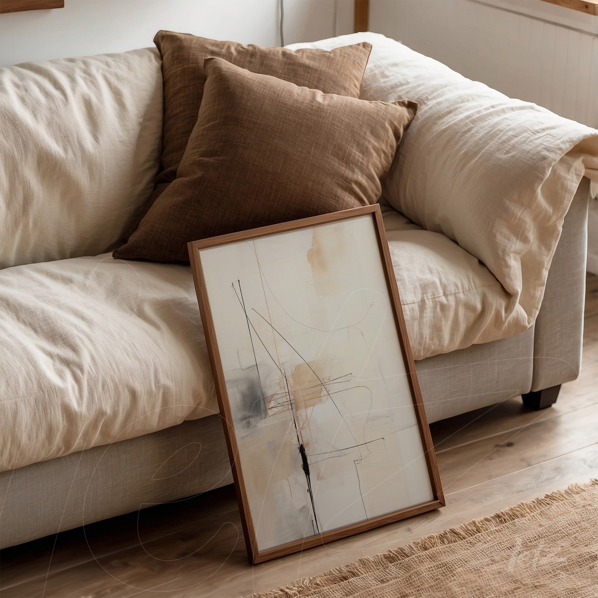 abstract artwork featuring lines in neutral tones leaning against a light sofa with brown cushions