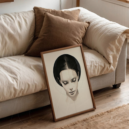 framed minimalist illustration of a female face with light wooden frame resting against a sofa with brown cushions
