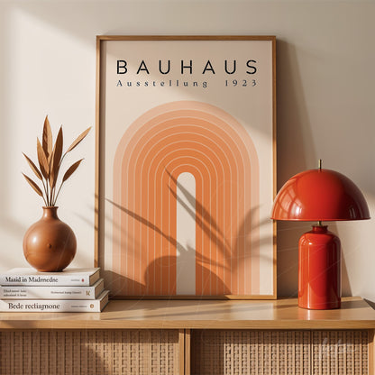 poster featuring vintage geometric design in earthy tones displayed in a wooden frame on a shelf with a red lamp and decorative vase