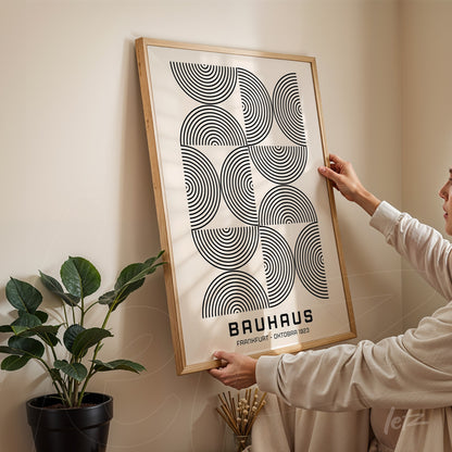 poster featuring geometric Bauhaus design in a light wood frame