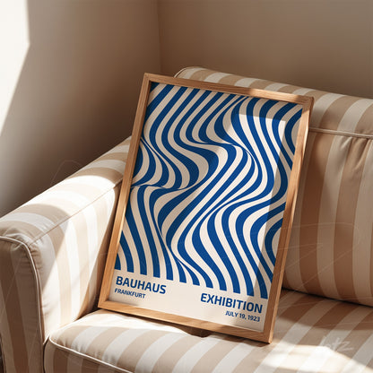 poster with blue wavy line pattern in wooden frame on striped sofa