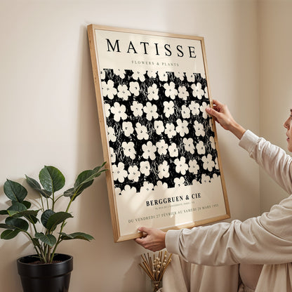 framed wall art featuring floral design by Matisse in light wood frame displayed on neutral wall