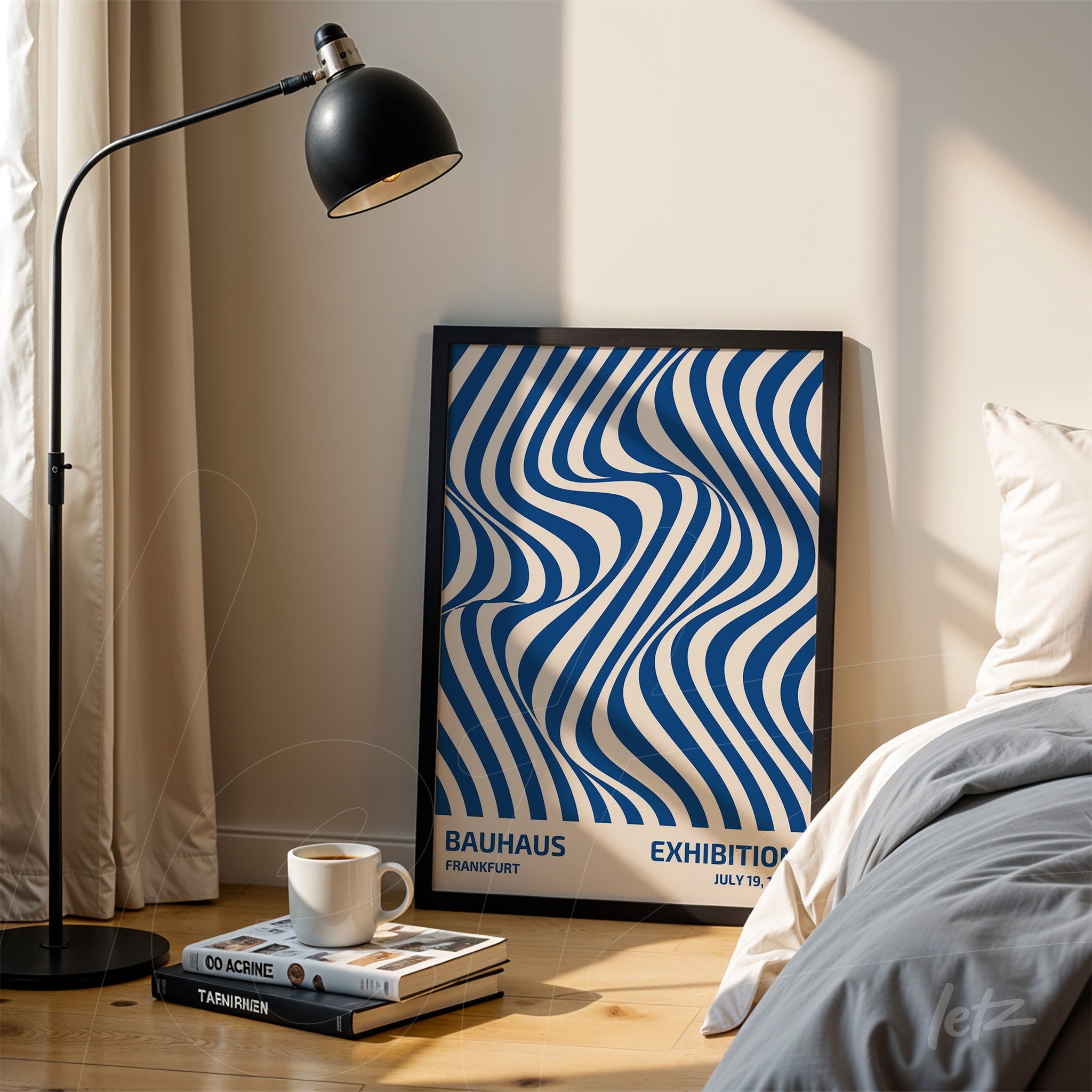 framed abstract art in blue and white tones displayed in a bedroom with cream wall