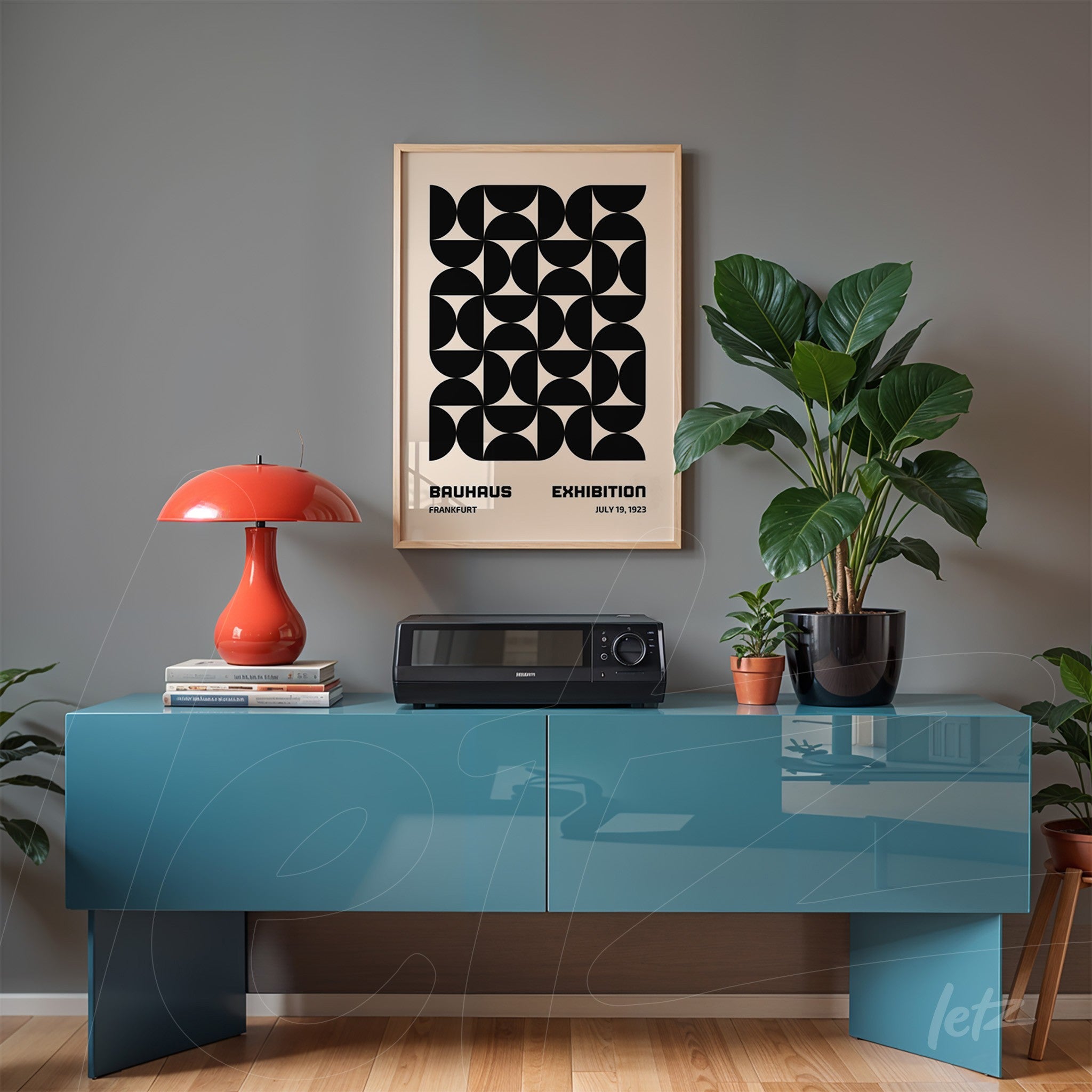 vintage poster with geometric black art in a light wood frame displayed on a gray wall above a blue sideboard with retro decor