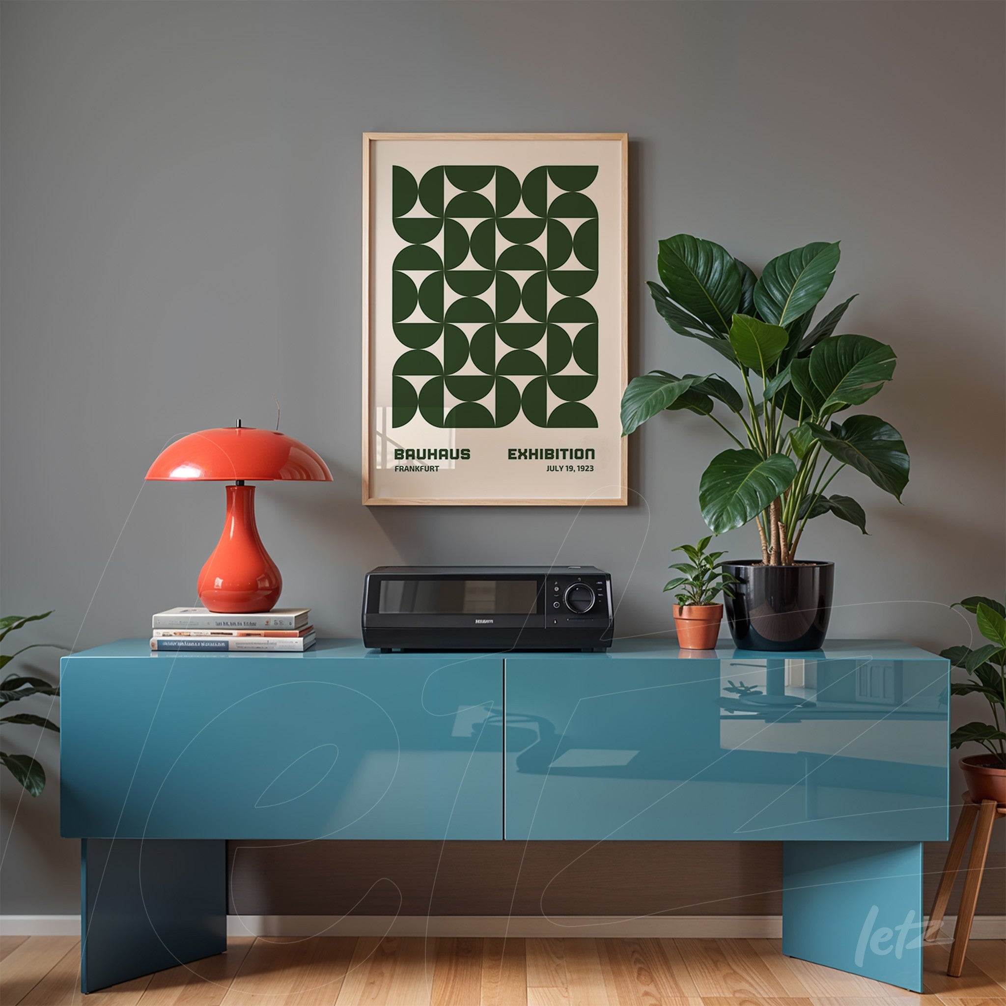 framed poster with green geometric design displayed above a blue sideboard in a modern room