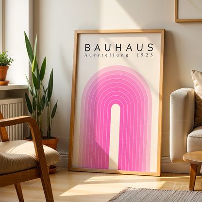 framed wall art with pink gradient arch design, displayed on living room floor with light wood frame
