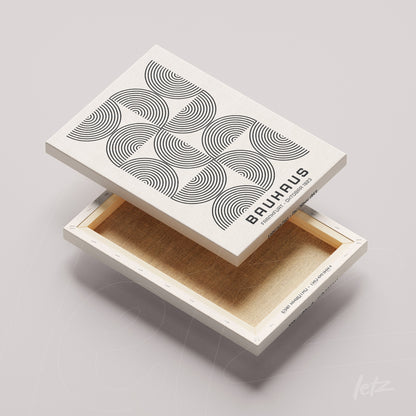 canvas print with black and white geometric art of concentric circles on a light beige background, shown flipped with edge visible