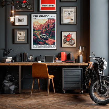 collection of wall art in gray featuring automotive themes, including a landscape poster of Colorado and vintage motorcycle photos, alongside a light wood desk with a leather chair and a classic motorcycle