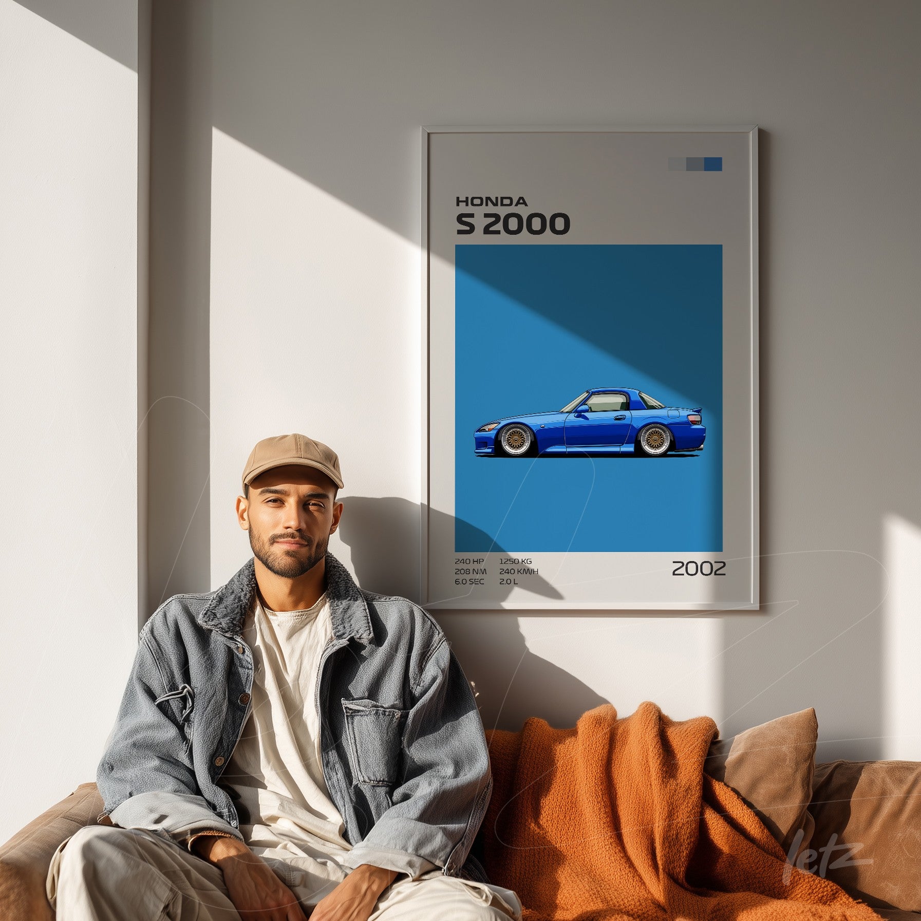 framed graphic art of Honda S2000 on light blue wall with a man sitting next to it on a sofa