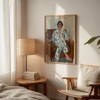 artwork featuring an expressive portrait of a man sitting on a sofa, wearing a blue floral robe, in a light wood frame displayed in a cozy interior