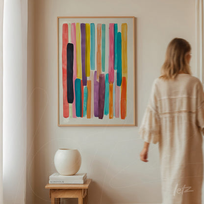 framed wall art featuring colorful abstract stripes in vibrant tones against a neutral wall