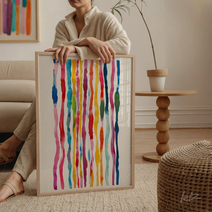 framed abstract wall art with vibrant colors displayed next to a wooden table