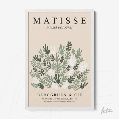 framed wall art featuring stylized botanical design with green and white leaves on light background, black typography, and white frame