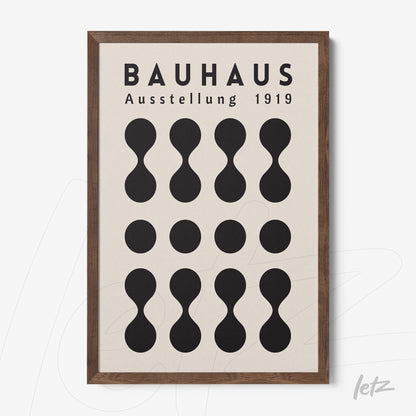 bauhaus poster with black geometric shapes on light background framed in dark wood