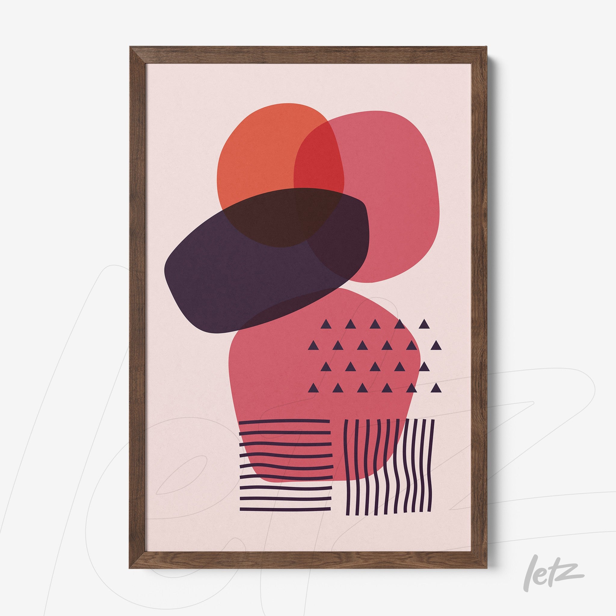abstract art with geometric shapes on light pink background framed in dark wood