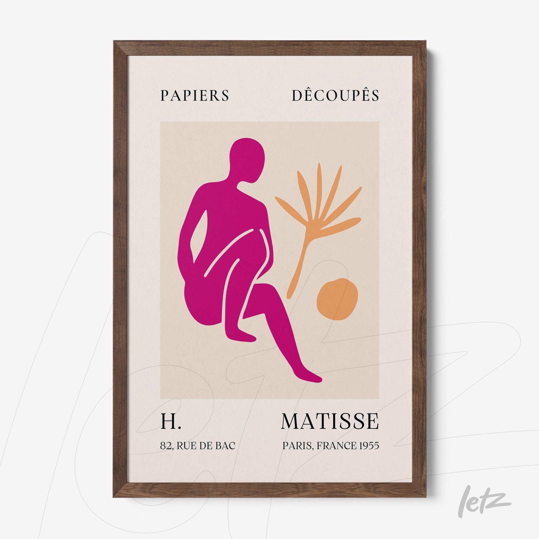 framed modern art featuring a vibrant pink figure sitting with a plant beside it on a light background and dark wood frame