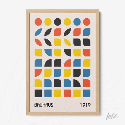 poster with colorful geometric Bauhaus style design from 1919 in light wood frame