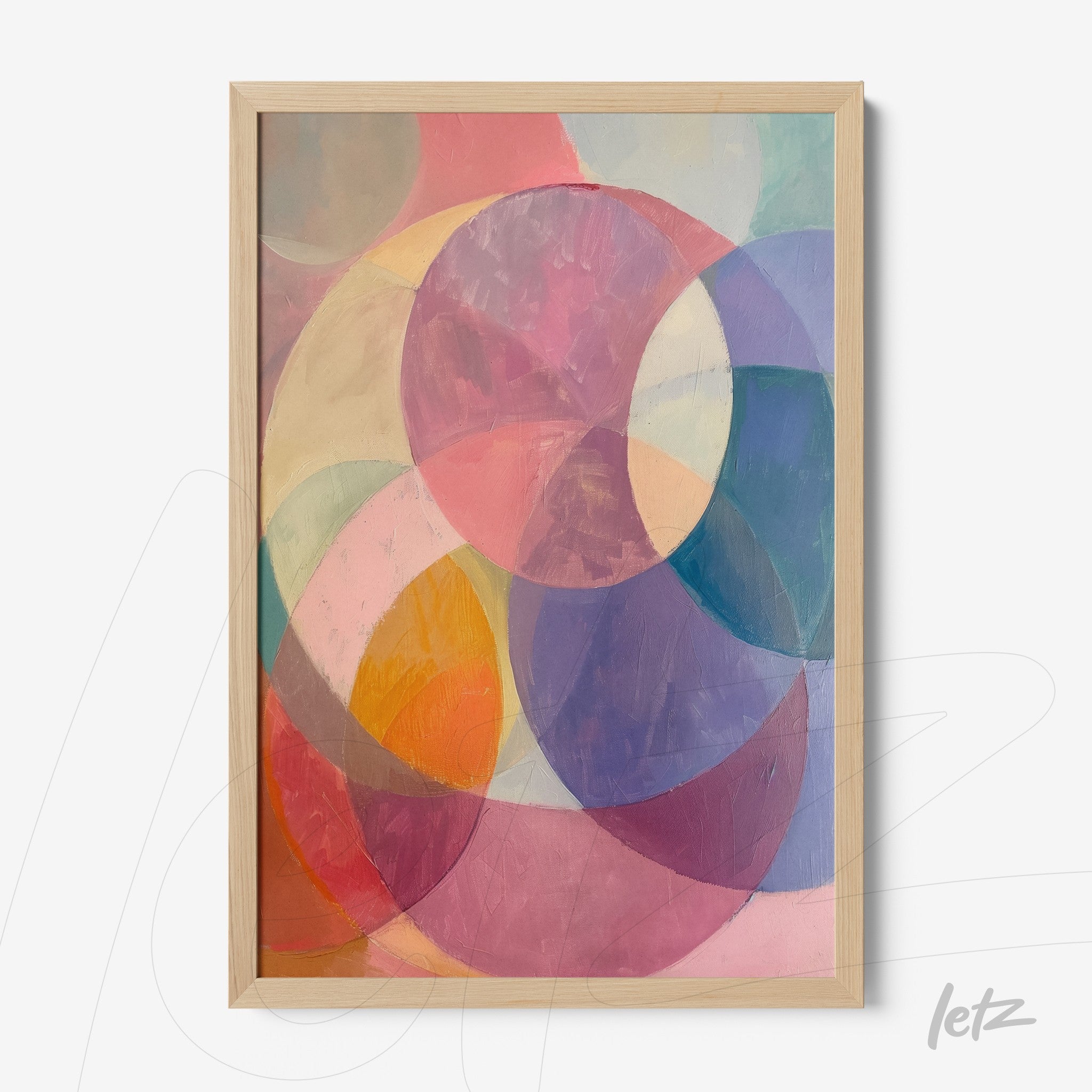 framed abstract art piece featuring pastel circles in a light wood frame