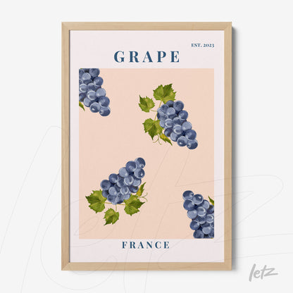 framed artwork featuring grapes on a pink background with light wood frame