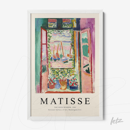 framed artwork by Henri Matisse depicting an open window with a view of a flower garden in a white frame