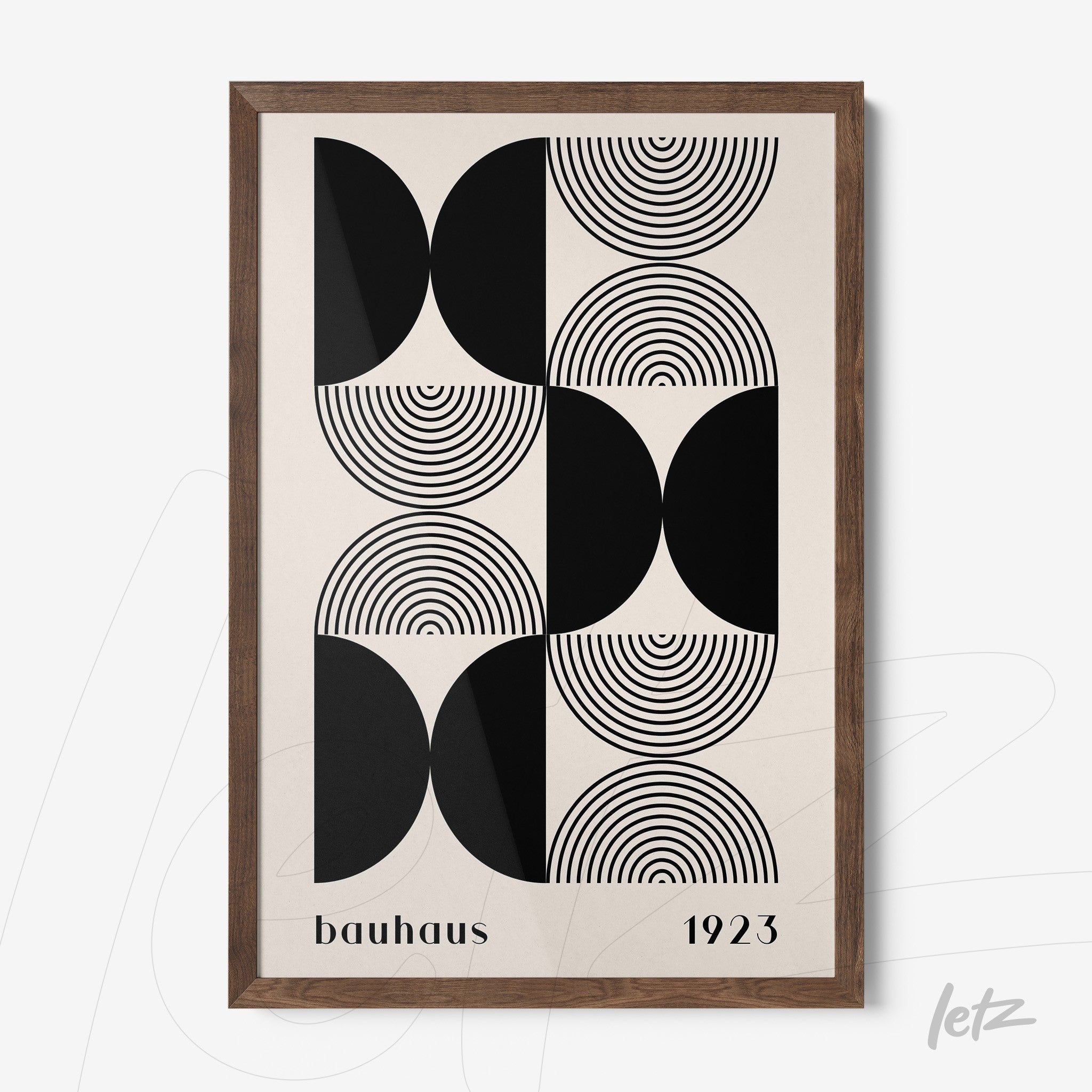 poster print with geometric bauhaus style art of black and white circles and semi-circles framed in dark wood
