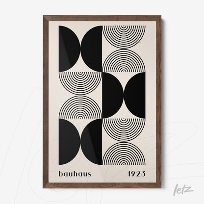 poster print with geometric bauhaus style art of black and white circles and semi-circles framed in dark wood